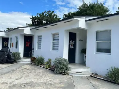 a white house with two blue doors at Villa Clara VIP-Little Havana in Miami
