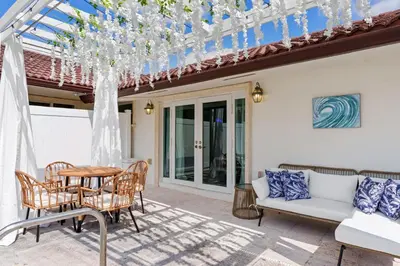 a patio with a table and chairs at Casa Santorini - Big Pool - Barbacoa - Fun and Relax in Miami