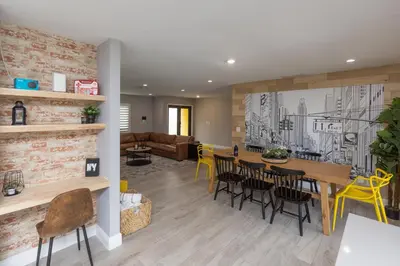 a dining room and living room with a table and chairs at Heated pool - 5min Coral Gables - Family Vacation in Miami