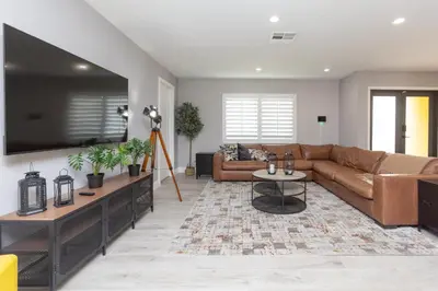 a living room with a couch and a tv at Heated pool - 5min Coral Gables - Family Vacation in Miami