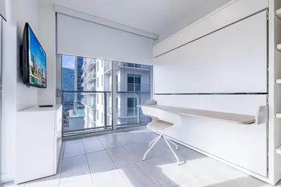 a white room with a desk and a large window at Charming 2 BR Downtown Miami 2106 Free Parking in Miami