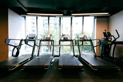 a gym with three treadmills in front of a window at Charming 2 BR Downtown Miami 2106 Free Parking in Miami