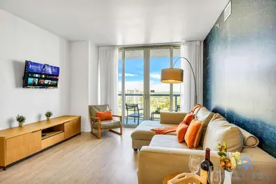 a living room with a couch and a tv at Spectacular Apartment with Amazing Pool in Hallandale Beach