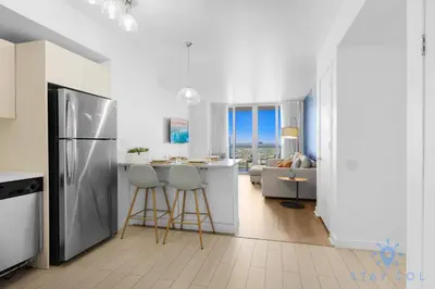 a kitchen with a refrigerator and a kitchen with a living room at Urban Apartment Balcony & Pool in Hallandale Beach