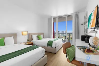 a hotel room with two beds and a balcony at Stylish Apartment Near Beach in Hallandale Beach