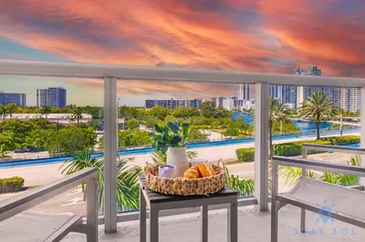 a basket of bread on a table on a balcony with a view of the city at Modern Resort -Balcony Views & Pool in Hallandale Beach