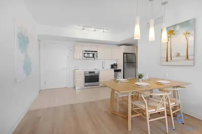 a kitchen and dining room with a table and chairs at Modern Resort -Balcony Views & Pool in Hallandale Beach