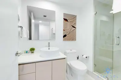 a bathroom with a toilet and a sink and a shower at Lovely Studio with Amazing Views & Pool in Hallandale Beach