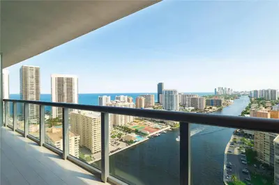 a view of the ocean from a balcony of a city at 2 BR Apartment with Balcony Pool View and Near Beac in Hallandale Beach