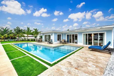 a swimming pool in the backyard of a house at Coral Shores Waterfront Heated Pool Hosts 14! in Fort Lauderdale