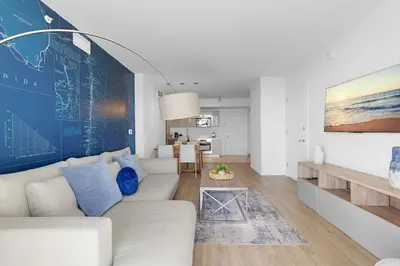 a living room with a couch and a table at 1 BR Apartment Modern Resort Balcony & Gym in Hallandale Beach