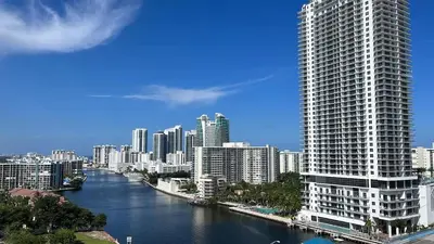 a city with a river and a tall building at Amazing Family Studio at Beachwalk on Hallandale in Hallandale Beach