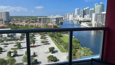 a balcony with a view of a river and a city at Amazing Family Studio at Beachwalk on Hallandale in Hallandale Beach
