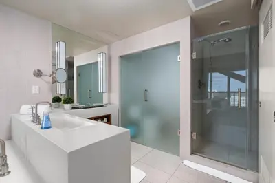 a bathroom with a sink and a shower at 2BR W Resort, Birds eye view of it all, Professionally Designed in Fort Lauderdale