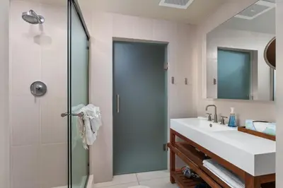 a bathroom with a sink and a shower at 2BR W Resort, Birds eye view of it all, Professionally Designed in Fort Lauderdale