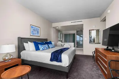 a bedroom with a large bed and a television at 2BR W Resort, Birds eye view of it all, Professionally Designed in Fort Lauderdale