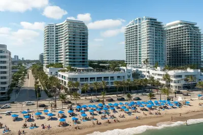 a beach with umbrellas and people on the sand and buildings at 2BR W Resort, Birds eye view of it all, Professionally Designed in Fort Lauderdale