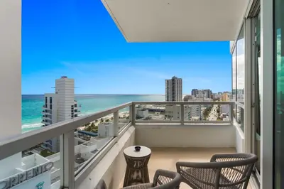 a balcony with chairs and a view of the ocean at Fontainebleau Hotel One Bedroom Suite in Miami Beach