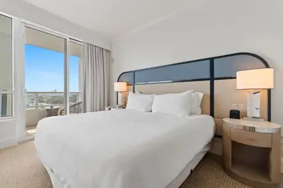 a bedroom with a large bed and a large window at Fontainebleau Hotel One Bedroom Suite in Miami Beach