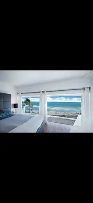 a bedroom with a large window with a view of the ocean at Luxury - Ocean front - Free Parking - 3 Bed 2 Bath in Miami Beach