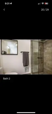 a bathroom with a shower and a toilet and a mirror at Luxury - Ocean front - Free Parking - 3 Bed 2 Bath in Miami Beach