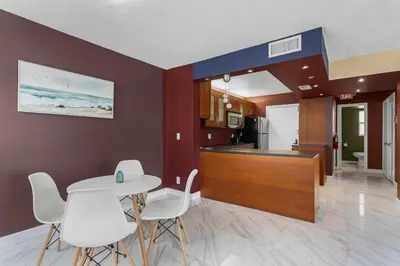 a kitchen and dining room with a table and chairs at Bay Harbor Sunset Apt 2A in Miami Beach