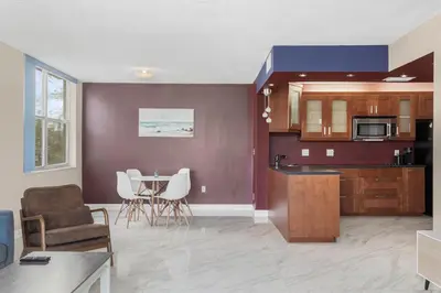 a kitchen and living room with a table and chairs at Bay Harbor Sunset Apt 2A in Miami Beach
