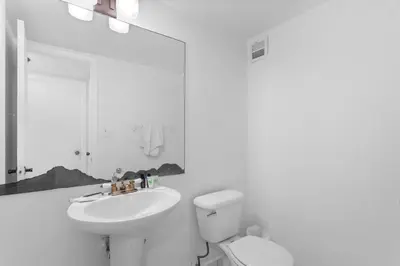 a white bathroom with a sink and a toilet at Bay Harbor Sunset Apt 2B in Miami Beach