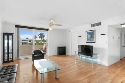 an open living room with a couch and a television at Bay Harbor Sunset Apt 2C in Miami Beach