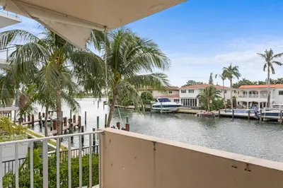 a view from a balcony of a river with boats at Bay Harbor Sunset Apt 2C in Miami Beach