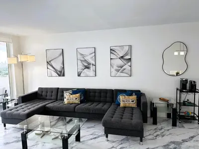 a living room with a couch and a table at Oceanfront Luxury Miami Escape Pool&Gym in Miami Beach