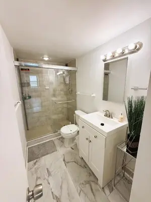 a bathroom with a shower and a toilet and a sink at Oceanfront Luxury Miami Escape Pool&Gym in Miami Beach