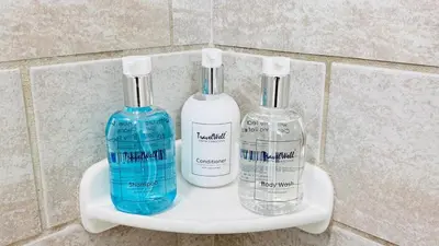two bottles ofodorizers sitting on a shelf in a bathroom at Oceanfront Luxury Miami Escape Pool&Gym in Miami Beach