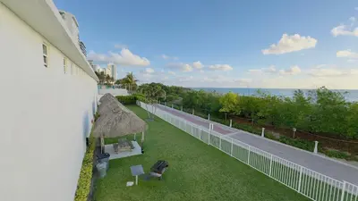 an aerial view of a balcony of a building with the ocean at Oceanfront Luxury Miami Escape Pool&Gym in Miami Beach