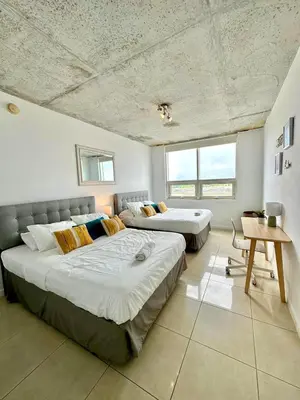 a bedroom with two beds and a table at Stylish and Spacious Condo Prefect to Enjoy Miami! in Miami