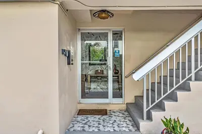 a staircase leading to a house with a glass door at Bay Harbor Sunset 3A in Miami Beach