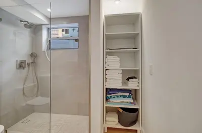 a bathroom with a walk in shower next to a glass door at Modern 2Bedroom in South Beach - Steps away from Lincoln Rd in Miami Beach