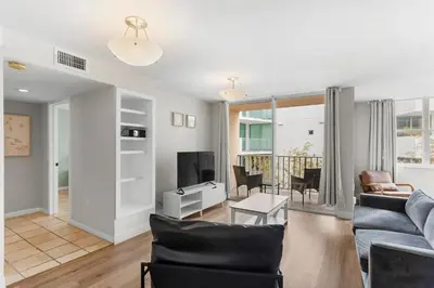 a living room with a couch and a tv at Bay Harbor Sunset Apt 3B in Miami Beach