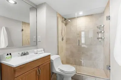 a bathroom with a toilet sink and a shower at Bay Harbor Sunset Apt 3B in Miami Beach
