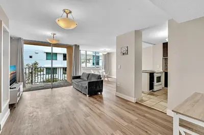 a living room with a couch and a kitchen at Bay Harbor Sunset Apt 3B in Miami Beach