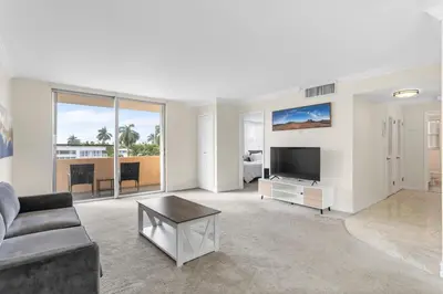 a living room with a couch and a tv at Bay Harbor Sunset Apt 3C in Miami Beach