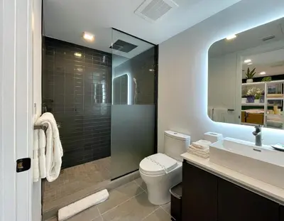 a bathroom with a toilet and a sink and a mirror at 227-2212AM DOWNTOWN MIAMI STUDIO in Miami