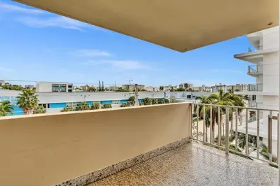 a balcony with a view of a building at Bay Harbor Sunset Apt 5A in Miami Beach