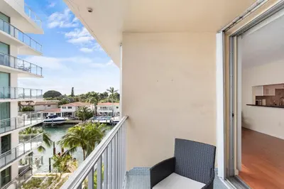 an apartment balcony with a view of the water at Bay Harbor Sunset Apt 5B in Miami Beach