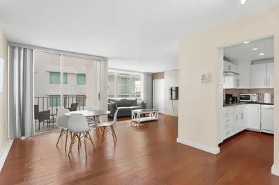 a kitchen and living room with a table and chairs at Bay Harbor Sunset Apt 5B in Miami Beach