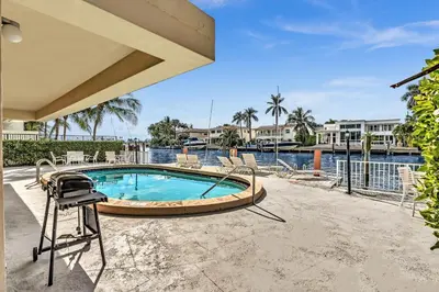 a swimming pool with a hot tub and a grill at Bay Harbor Sunset Apt 5C in Miami Beach