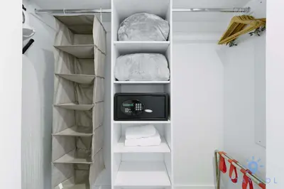 a walk in closet with a tv and shelves at Stylish Apartment Pool & Balcony in Hallandale Beach