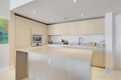 a kitchen with white cabinets and a counter top at Apartment with Ocean View Balcony in Hollywood