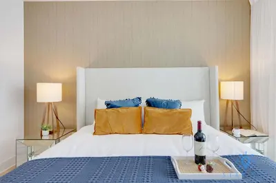 a bedroom with a large white bed with two lamps at Apartment with Ocean View Balcony in Hollywood