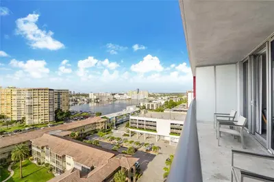 a balcony with a view of a river and buildings at Spectacular Apartment with Balcony & Pool in Hallandale Beach